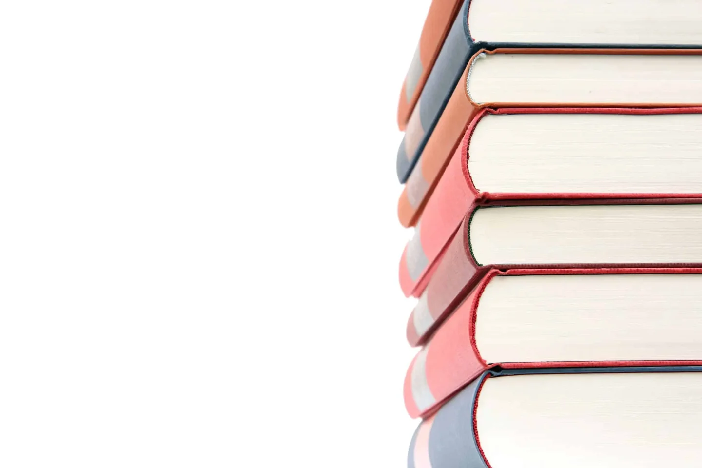 A vertical stack of hardcover advertising books with red, blue, and beige covers is shown against a white background, with the spines facing right and the pages visible on the left.