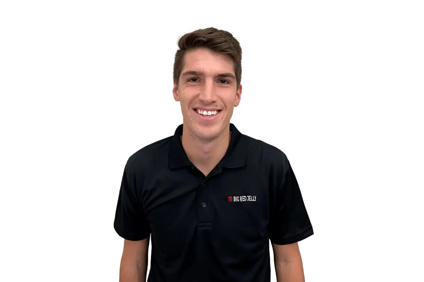 A young man with short brown hair smiles at the camera. He is wearing a black collared shirt with a small BIG RED CELL logo on the left side, representing a team of digital marketing experts. The background is plain white.