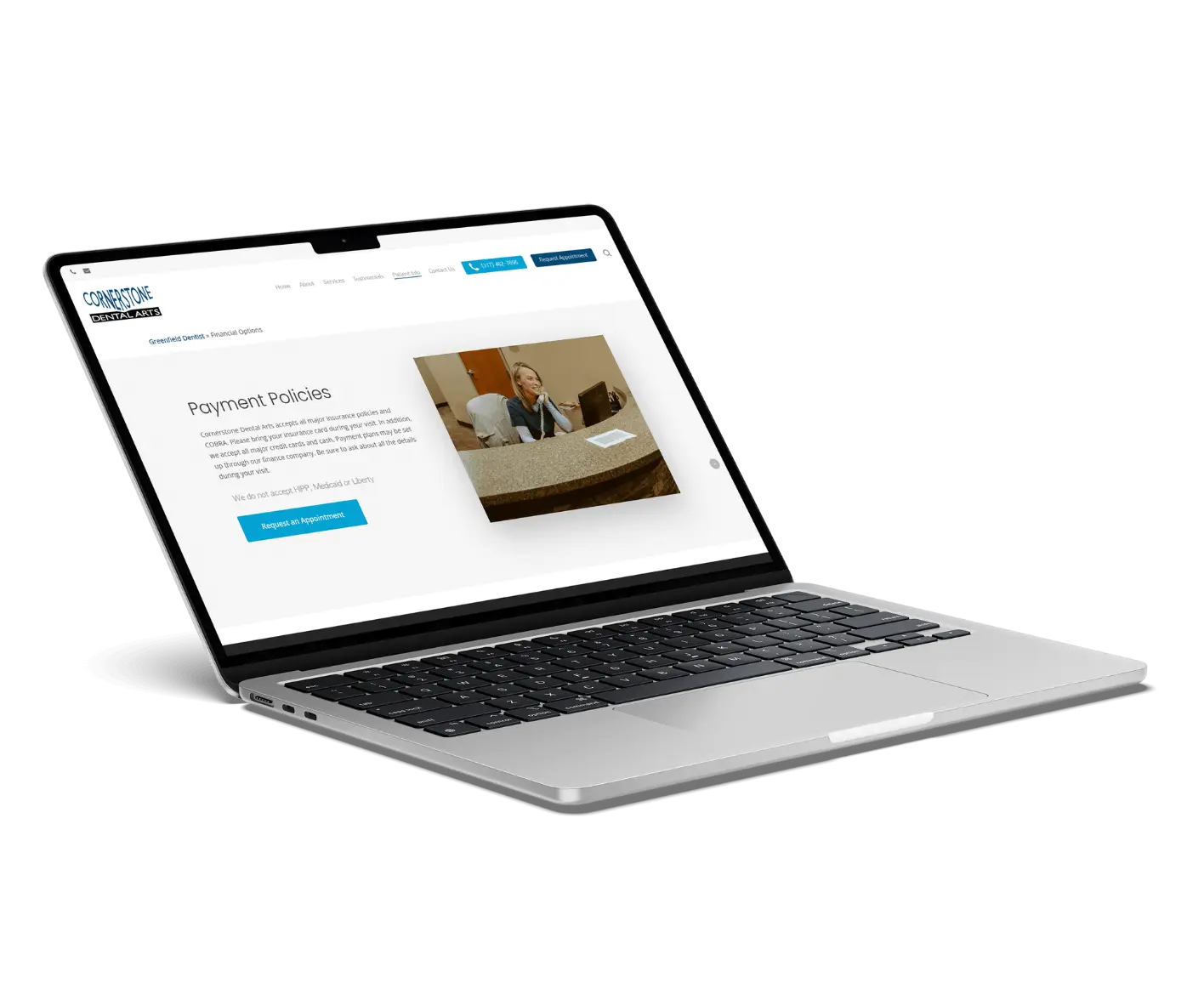 A silver laptop displays a website page titled Payment Policies, featuring a photo of a smiling receptionist at a desk and a blue Request an Appointment button.