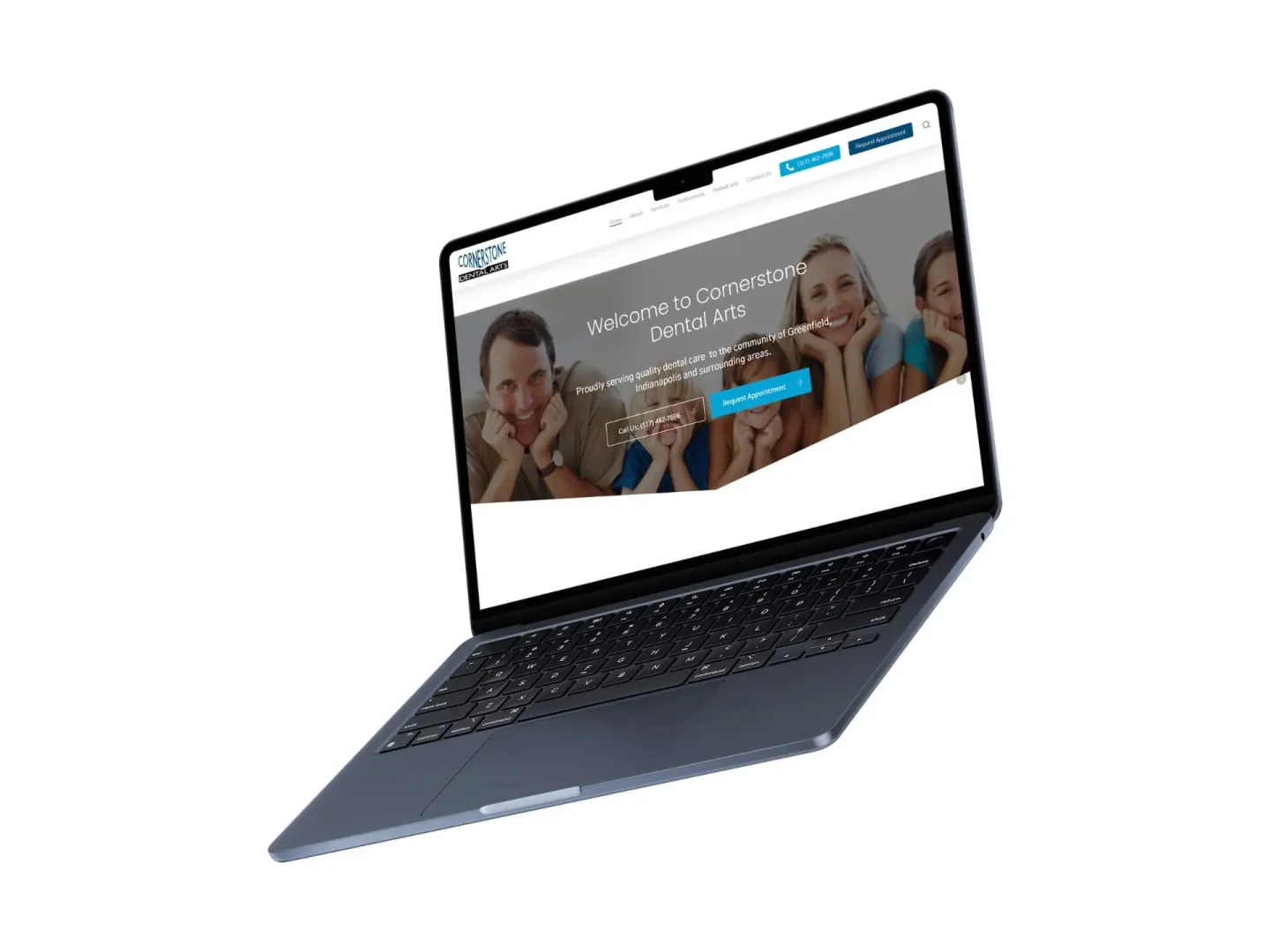 A laptop displaying the Cornerstone Dental Arts website homepage, featuring a smiling family in the banner, with navigation links and a blue “Request an Appointment” button visible on the screen.