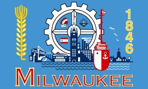 Illustration of Milwaukee symbols—gear, city skyline, church, ship, wheat stalk, and 1846—with MILWAUKEE in bold yellow and red letters below. A great example to consider when learning about the 5 Things Not To Do With Your Logo Design.