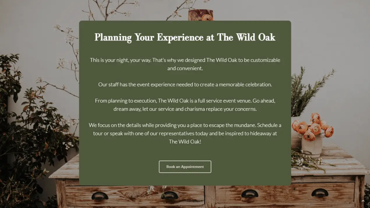 The Wild Oak Venue Portfolio 4 A green invitation card on a wooden table reads: Planning Your Experience at Wild Oak Venue with details about customizable event services, encouraging booking an appointment. Dried branches and pots are in the background.