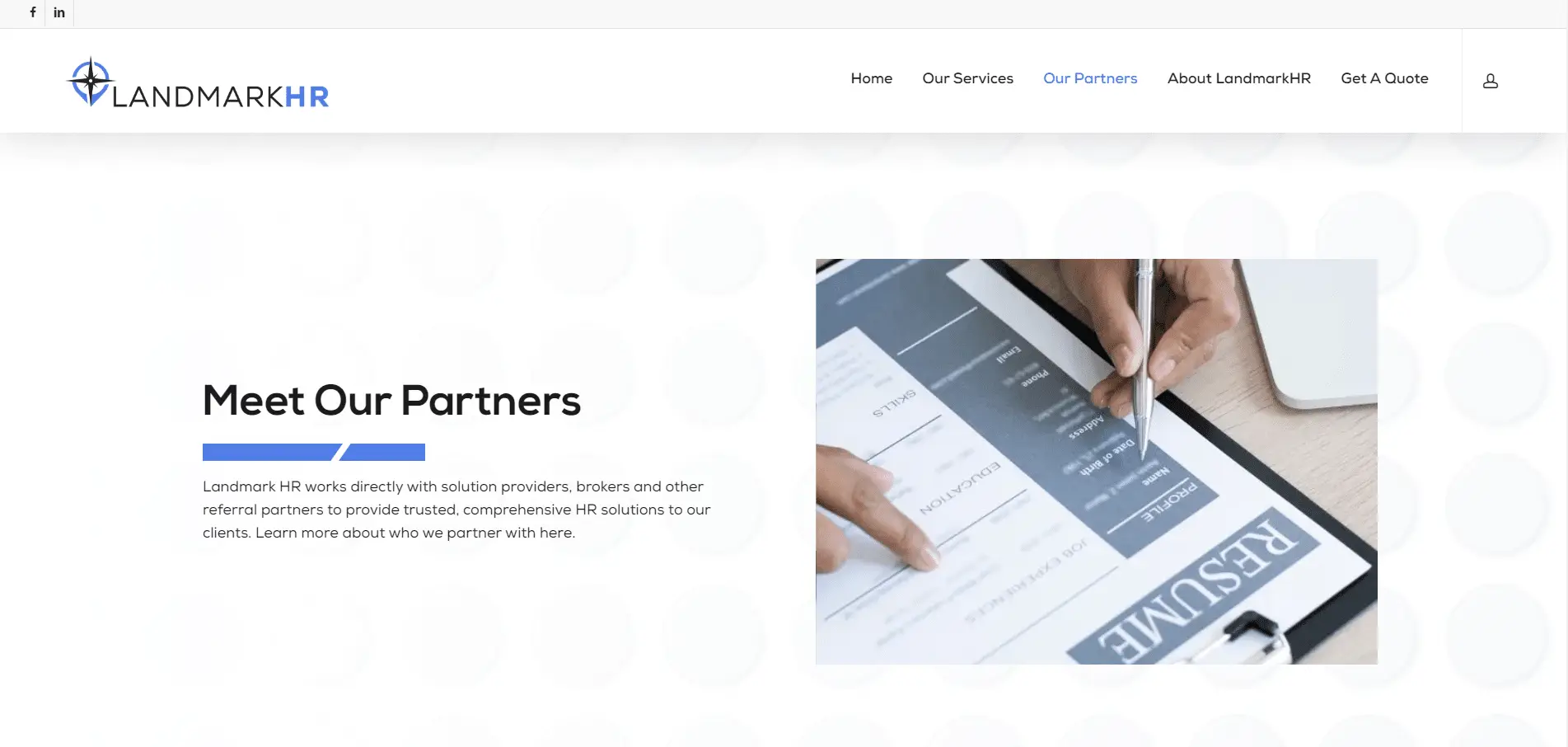 Landmark-HR-Portfolio-3 A close-up of two hands reviewing a printed resume on a clipboard. To the left, text reads Meet Our Partners with a description about Landmark HR partnering with solution providers for clients. Website menu is visible at the top.