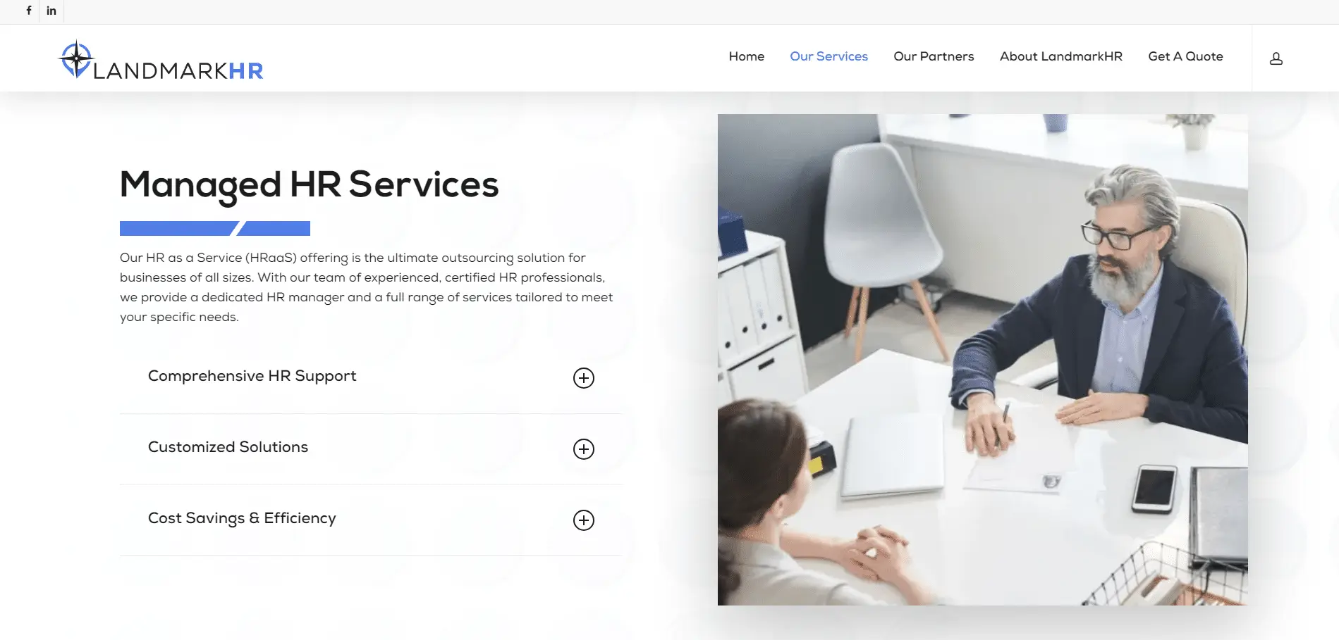 Landmark-HR-Portfolio-6 A gray-haired man in glasses speaks with a woman across a desk in a modern office. Text on the left describes LandmarkHR’s Managed HR Services, listing HR support, customized solutions, and cost savings.