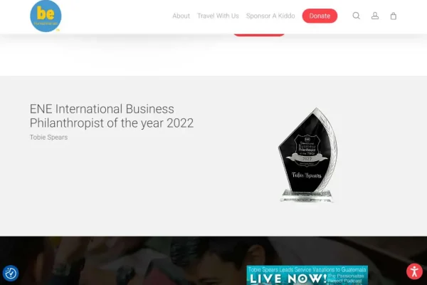 BeHumanitarian - Final 3 A website page displays the ENE International Business Philanthropist of the year 2022 award, given to Tobie Spears, with an image of a black and clear glass trophy on the right side.