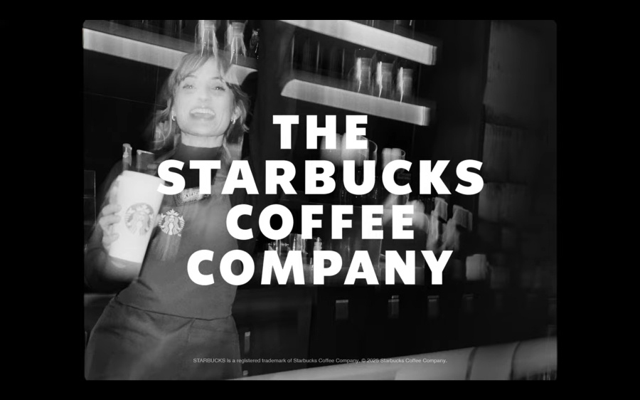 A black-and-white photo of a smiling barista holding a Starbucks cup behind a counter, with large bold text reading THE STARBUCKS COFFEE COMPANY across the image.