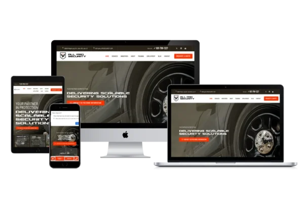 A security solutions website displayed responsively on four devices—a smartphone, tablet, laptop, and desktop—all showcasing the same homepage with a sleek black and orange color scheme, similar to Pioneer Valley Dental's modern web design.