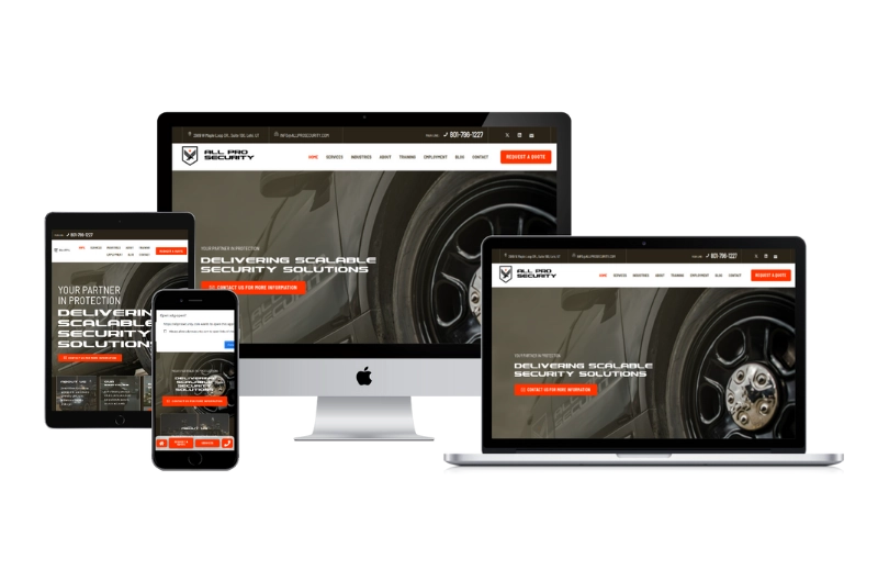 A security solutions website displayed responsively on four devices—a smartphone, tablet, laptop, and desktop—all showcasing the same homepage with a sleek black and orange color scheme, similar to Pioneer Valley Dental's modern web design.