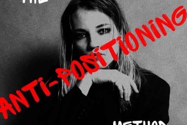 A black-and-white photo of a person in a dark jacket with their hand near their chin. The words THE ANTI-POSITIONING METHOD are written in bold, red and white text across the image.