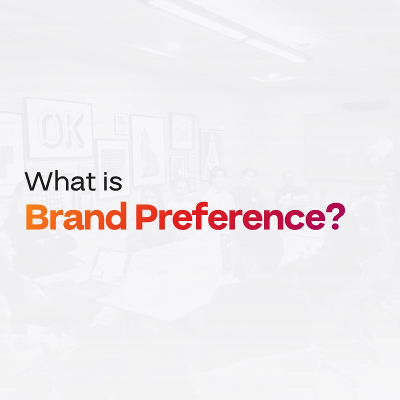 什么是品牌偏好?这段文字出现在一张褪色的背景图片上,图片中人们在一间现代办公室里开会,墙上挂着装裱好的艺术品。