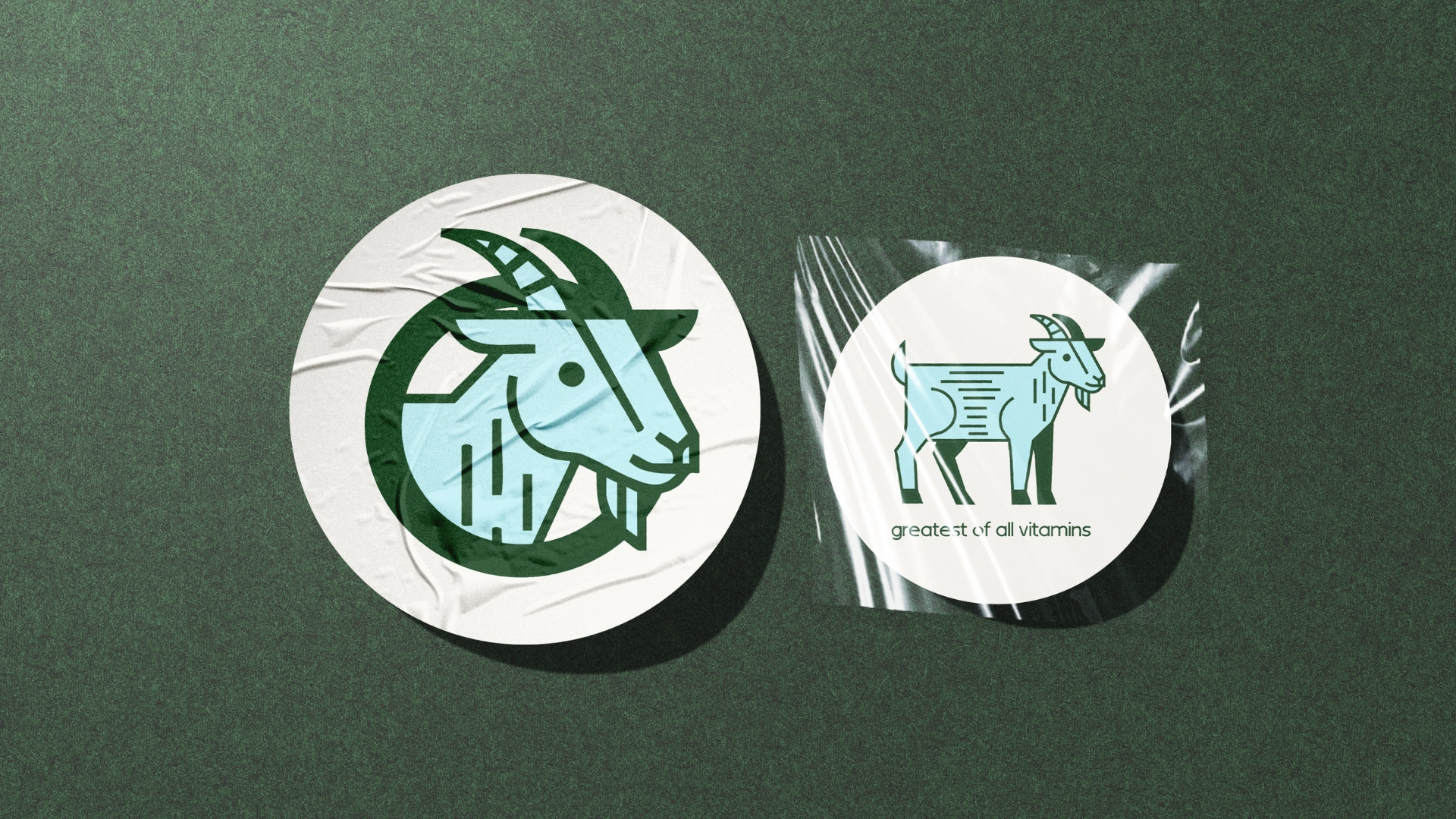 Two circular stickers with goat illustrations on a green background. The left sticker shows a stylized goats head; the right shows a full goat with the text greatest of all vitamins.