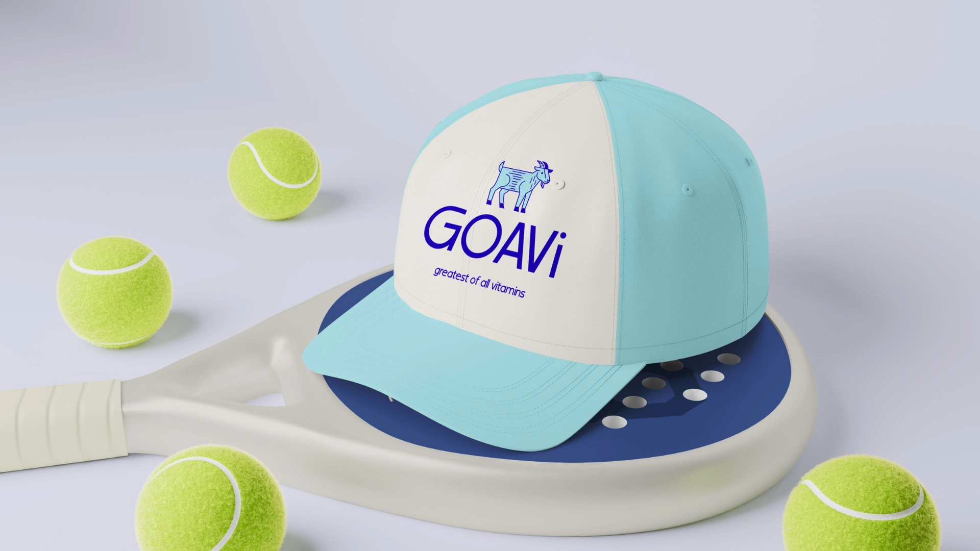 A light blue and white cap with GOAVi greatest of all visitors and a blue animal logo sits on a white and blue tennis racket, surrounded by four tennis balls on a light surface.