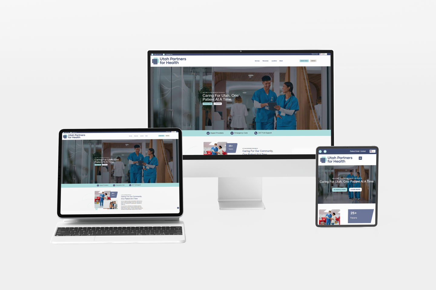 A health care website homepage is displayed on a desktop monitor, laptop, and tablet at Strawberry Bay Marina, showing medical professionals walking and health-related messaging on a clean, modern interface.